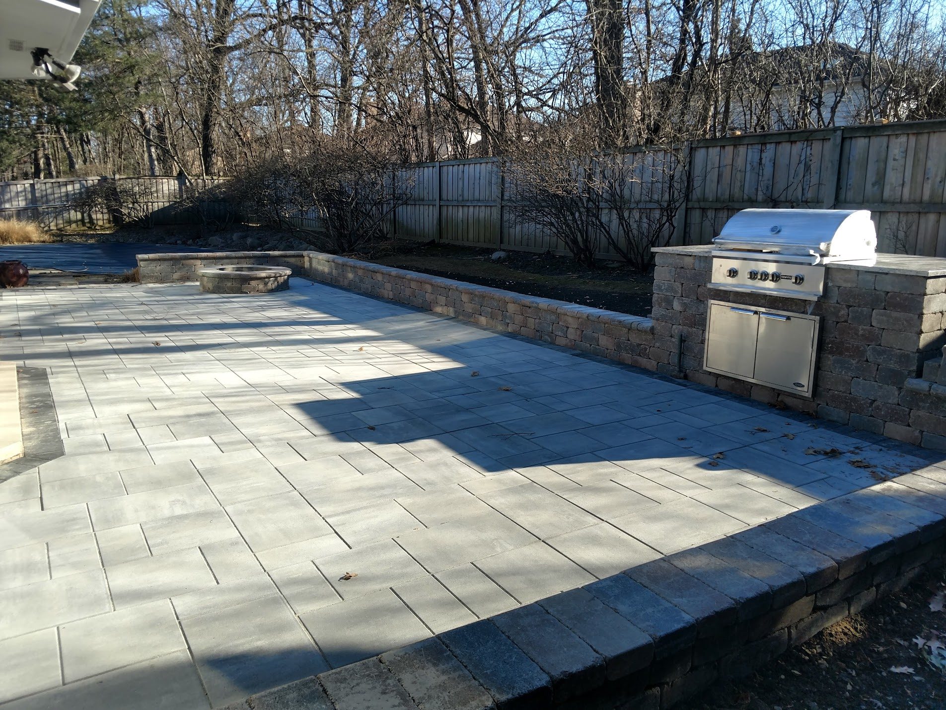Large dark paver patio with built-in grill station