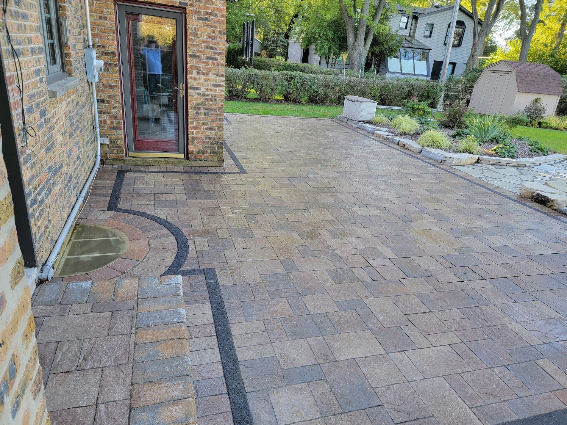 Curved paver driveway leading up to a Chicagoland home