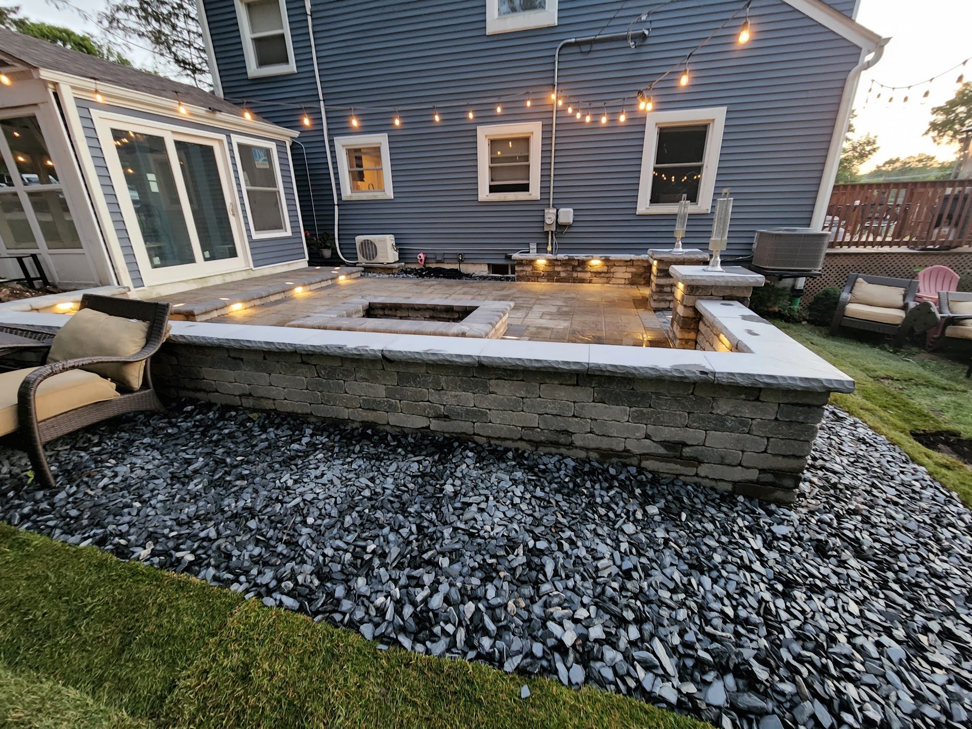Backyard fire pit with string lights