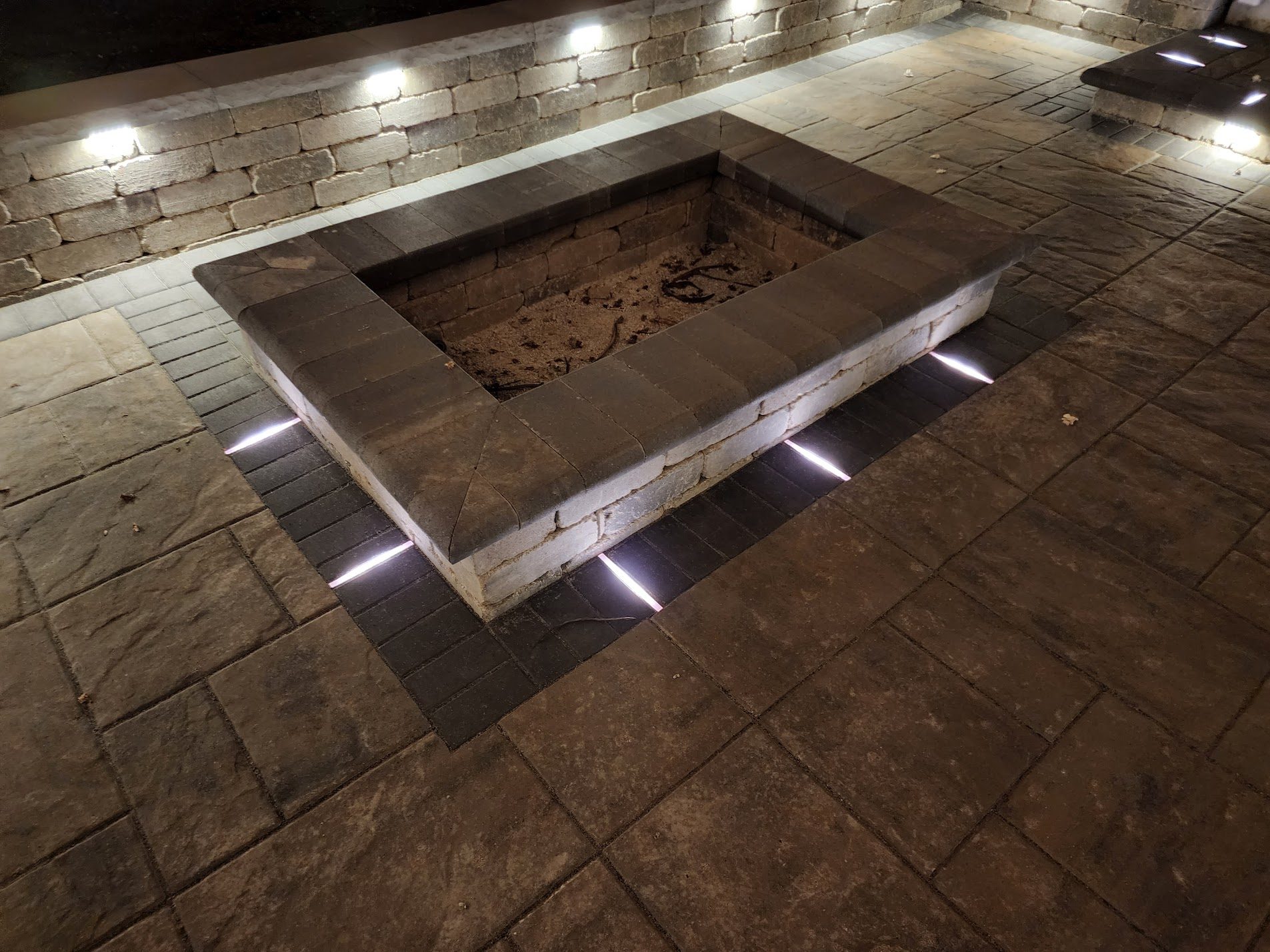 Square fire pit on stamped concrete patio