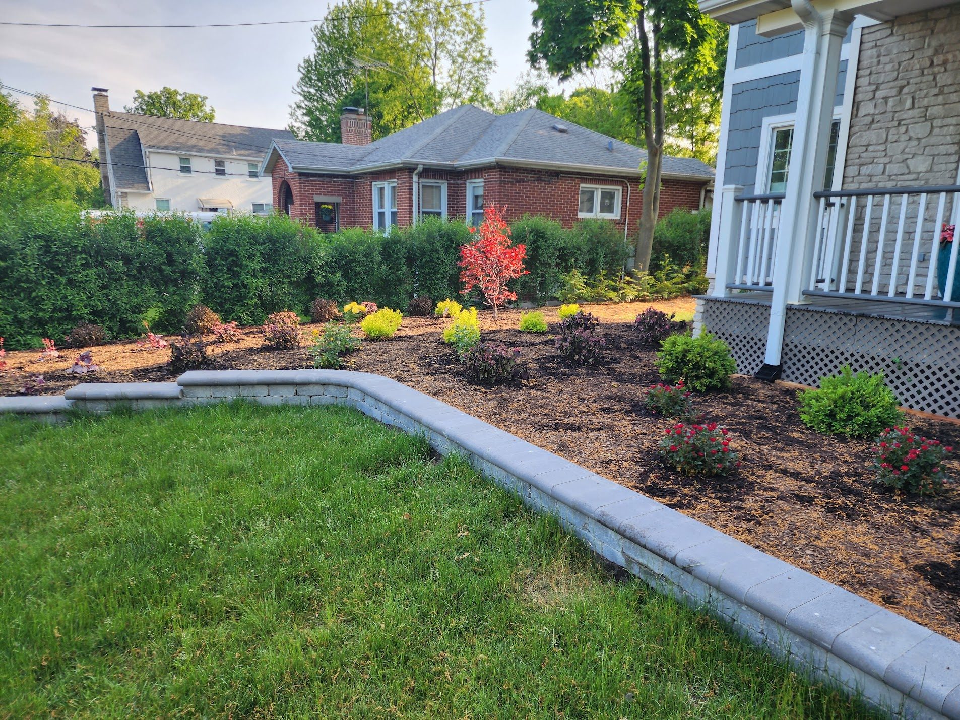 Front yard with fresh mulch and trimmed shrubs