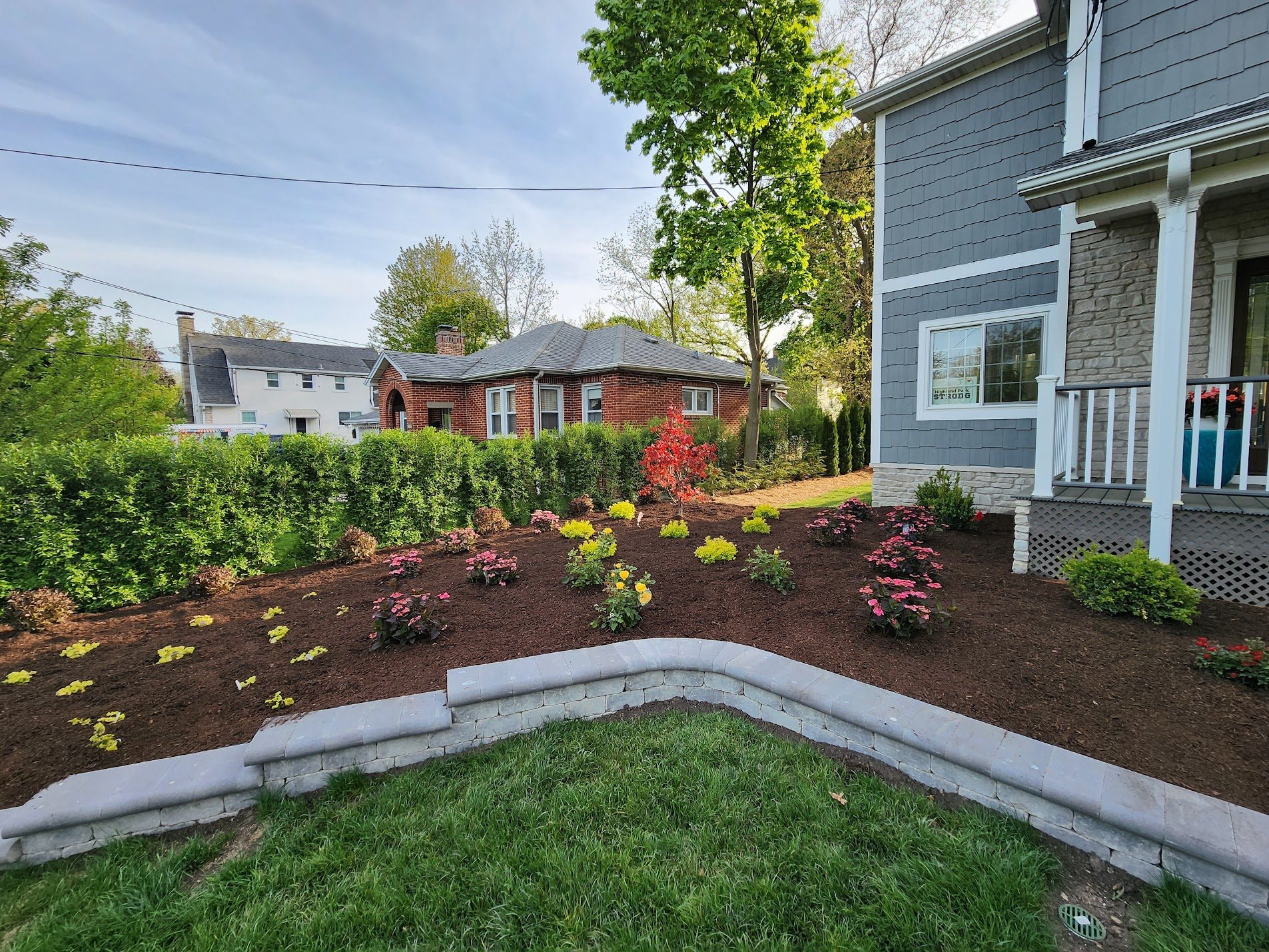 Front yard with stone border and flowers