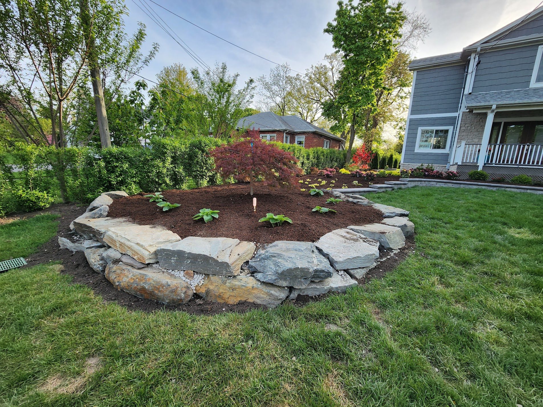 Artistic rock garden with boulders and curated plantings