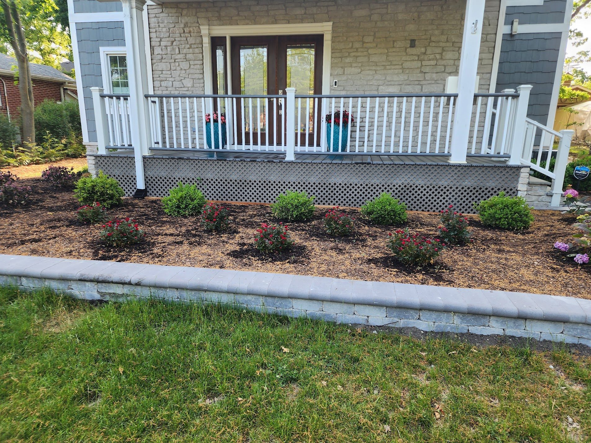 Porch with elegant foundation landscaping