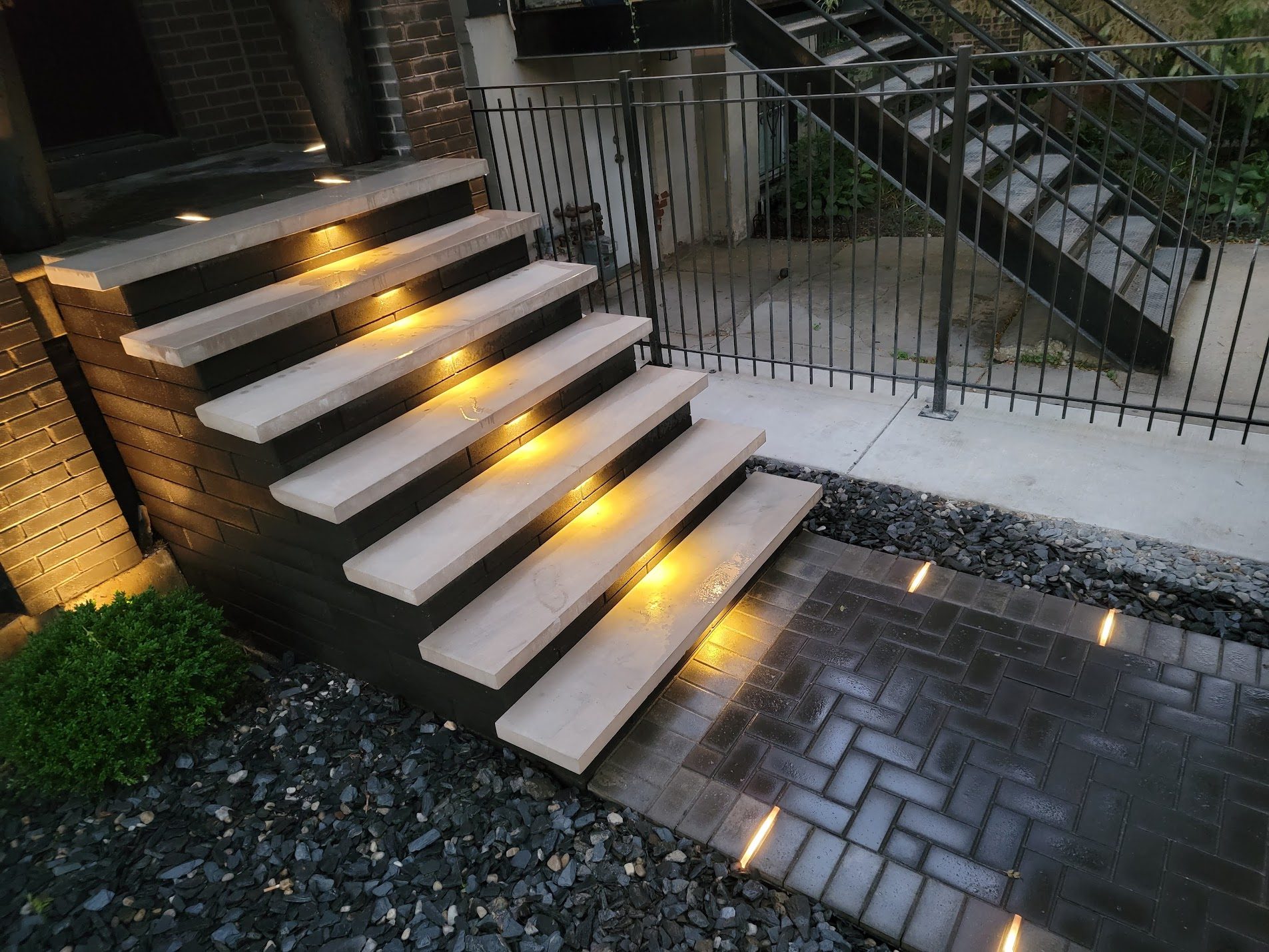 Illuminated stone steps at night with accent lighting