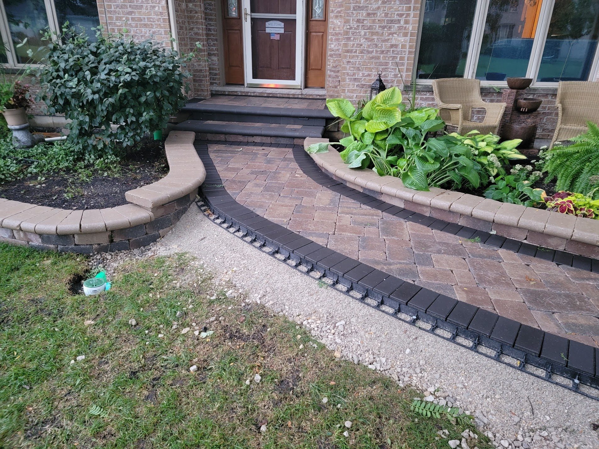 Curved brick walkway with stone border