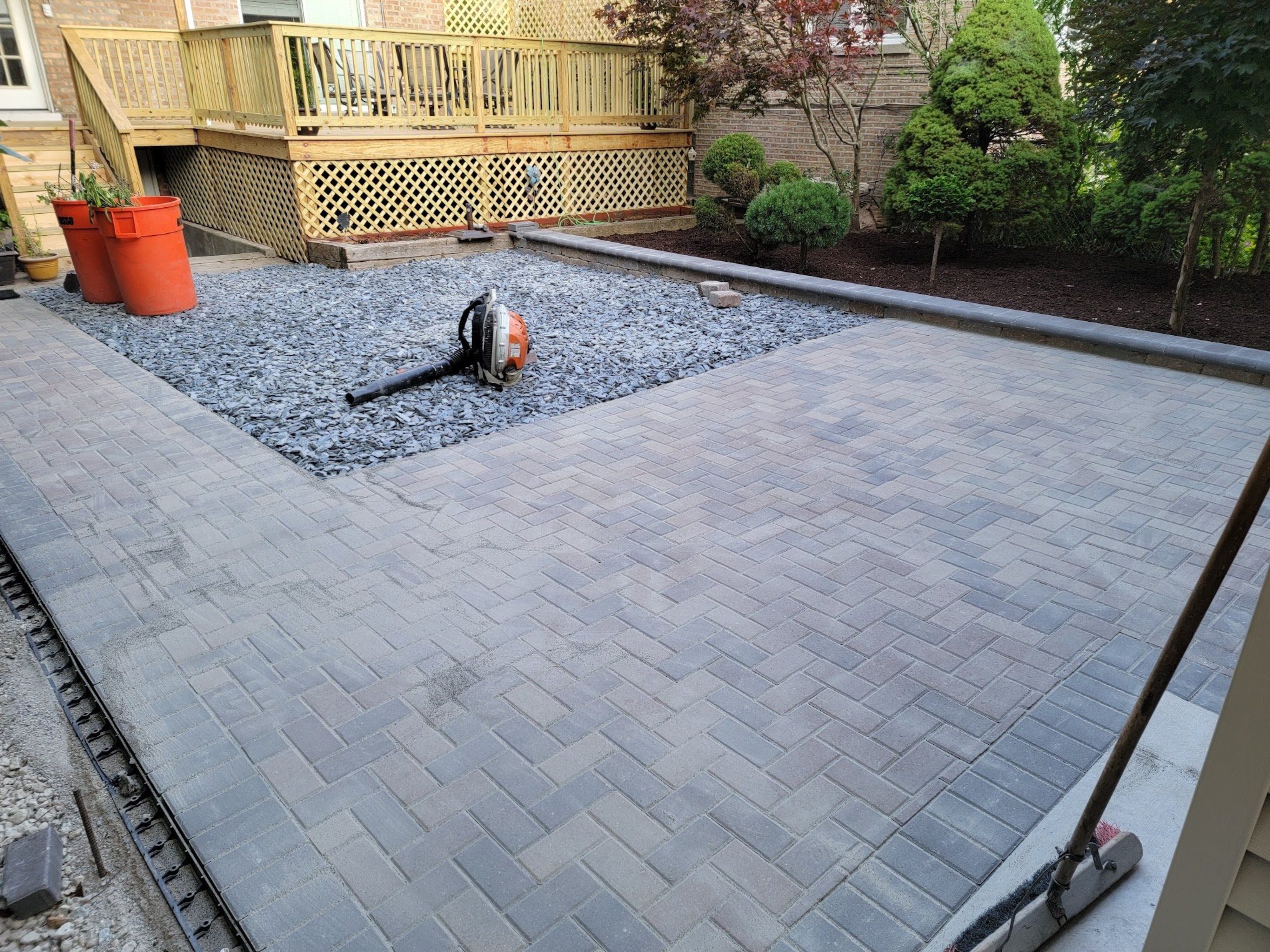 Worker installing paver walkway