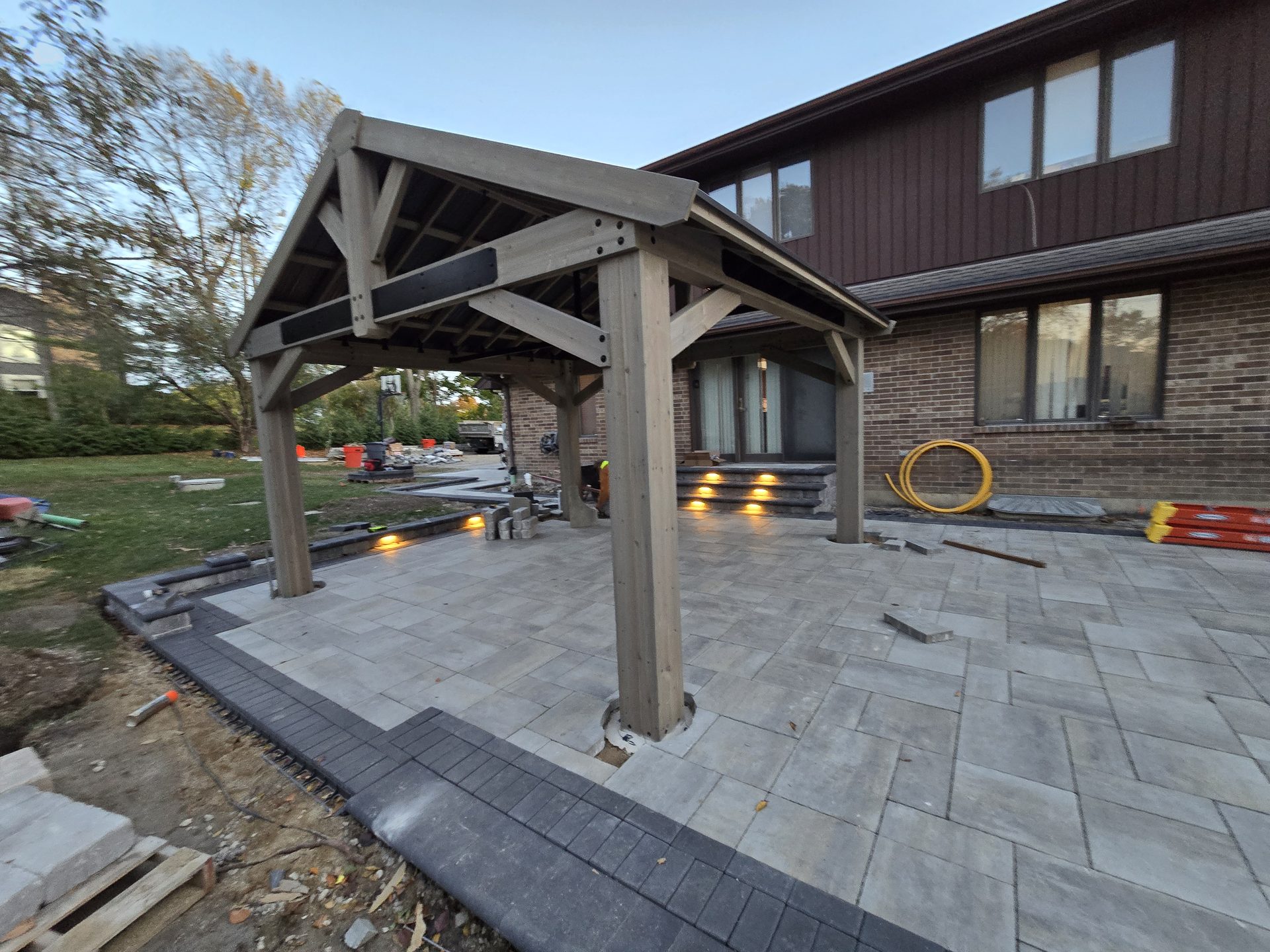 Angle view of a timber pavilion over a finished paver patio